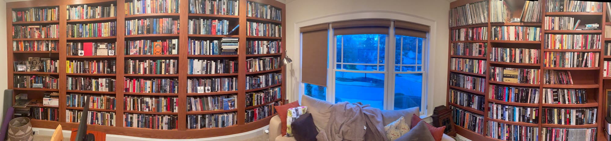 Picture of room with floor to ceiling bookshelves on two sides. 