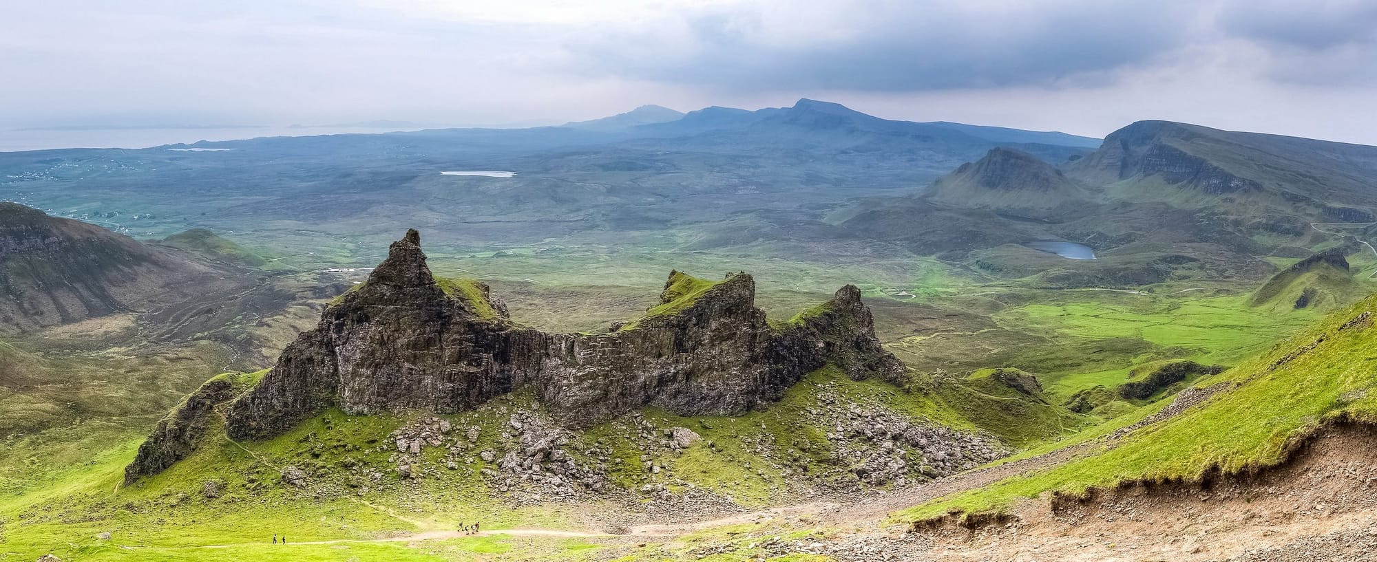 Picture of Scottish highlands, with stones and distant mountains.